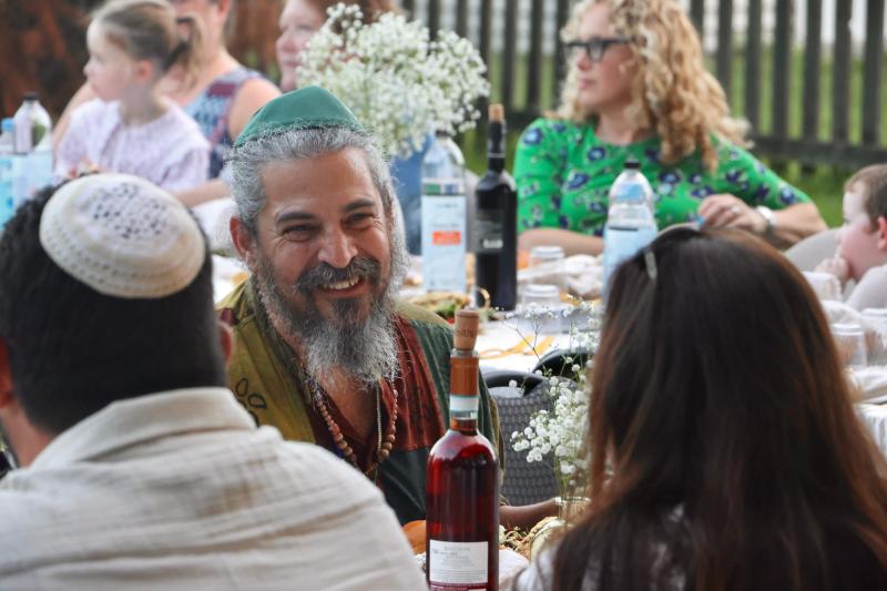 Craig Miller enjoys conversation at the table during Shabbat Under the Stars.