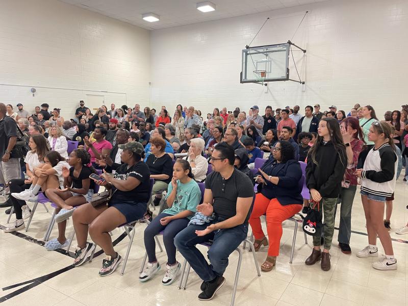 A large crowd of students and parents fills the school’s gymnasium during the event.