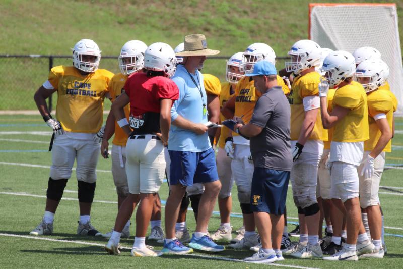 Coaches Mike Frederick and Mike Gunther are in the huddle for the first football scrimmage at Delaware Military Academy. SUBMITTED PHOTO