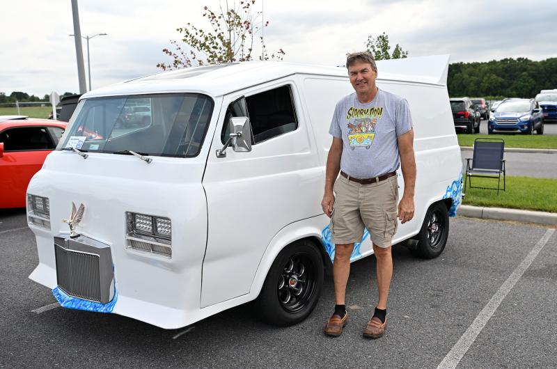 Ron Laustsen stands with his custom 1966 Ford Econoline.