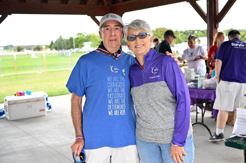 Rob Smith, left, and Bonnie McIlvain share a hug at the survivors dinner.