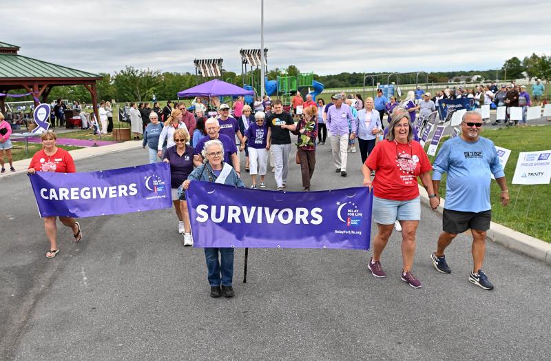 Survivors and caregivers pace around the Circle of Hope at Sandhill Fields for the Relay for Life Sept. 7. DAN COOK PHOTOS
