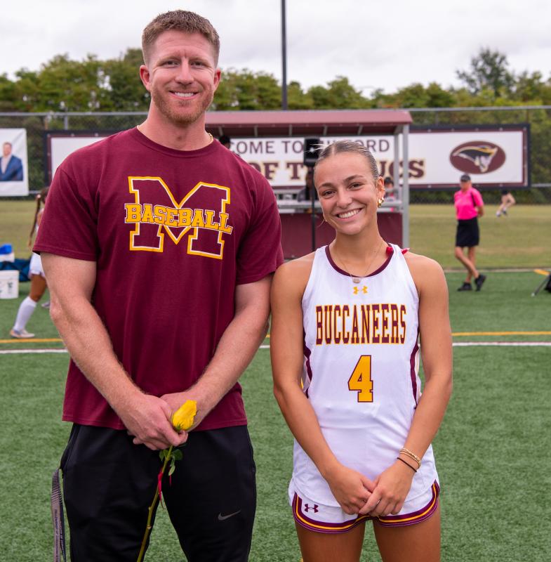 Steve Walker, teacher, and Bailey Masten, hockey player, on Teacher Appreciation Night.