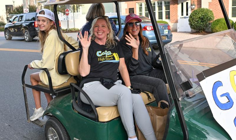 Cape Principal Kristen DeGregory waves to the crowd along the parade route.