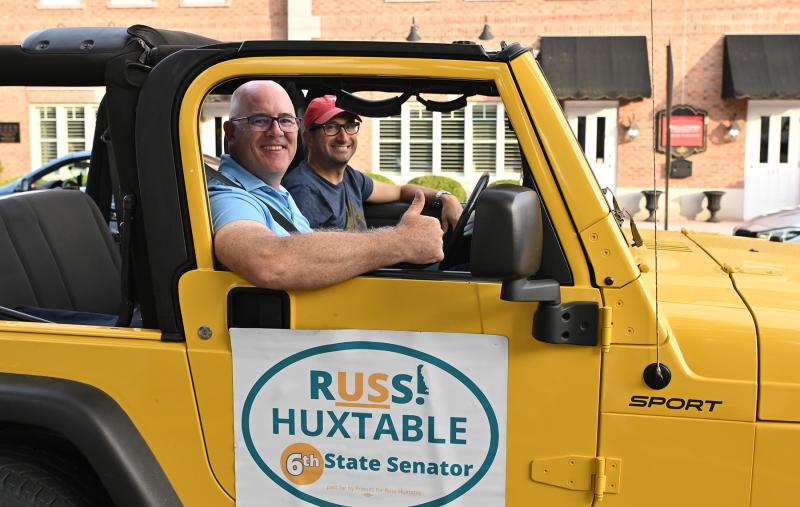 Mike DiPaolo, right, drives Sixth District Sen. Russ Huxtable up the parade route.