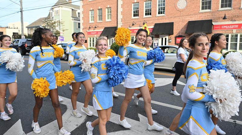 Cape cheerleaders walk up Savannah Road to Legends Stadium.