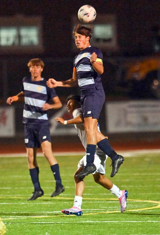Cape defender Jerzy Haines heads a clear for the Vikings.