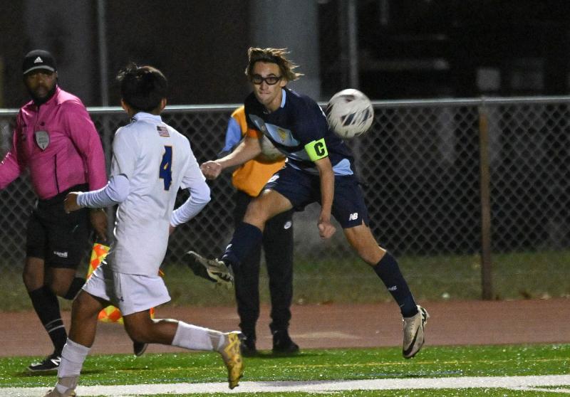 Cape senior captain Cardin Benjamin centers the ball from the sideline.