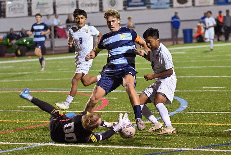 Central keeper Justin Glasco makes a save on a rush from Cape’s Evan Burris.