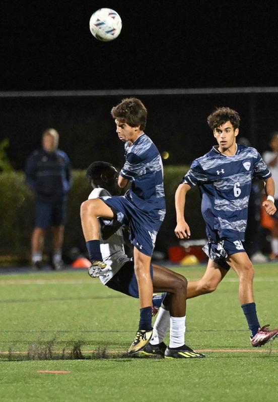 Sussex Academy freshman Bodhi Williams makes a high pass upfield.