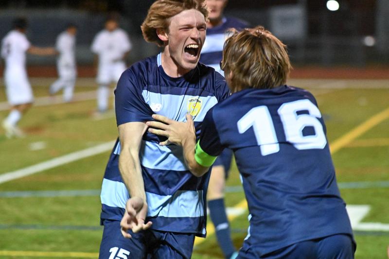 Brady Spiegel celebrates with Cardin Benjamin after the Vikings tied the game at 2-2 near the end of regulation.