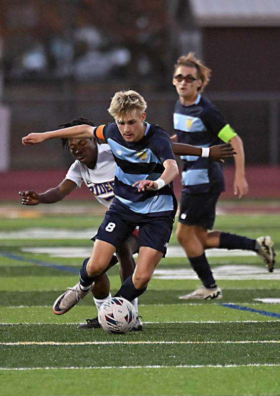 Seth Benjamin controls the ball in the midfield.