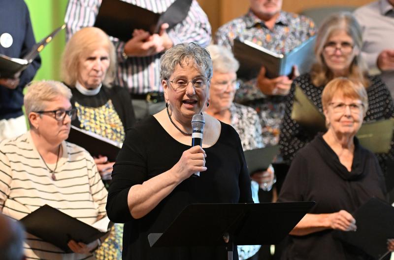 Judy Moore leads the choir and coordinated the music for the event.