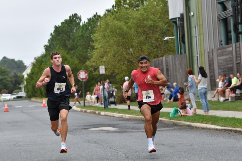Mason Morrone of Lewes, left, races Ariel Simbana of Millsboro to the finish line.