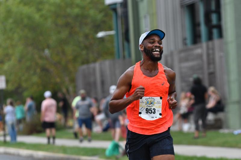 Anthony Wamwea of Baltimore is all smiles as he finishes in 23:33.