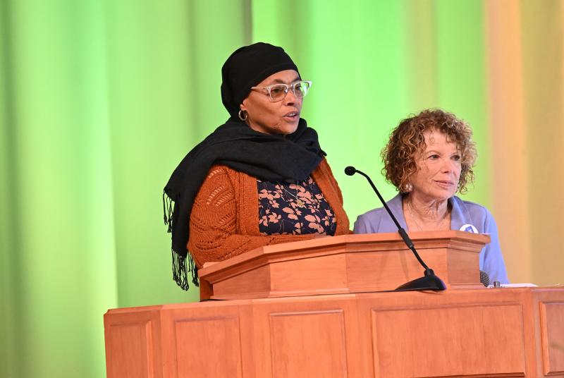 Muriel Watkins of the Islamic Society of Central Delaware reads from the Quran while Marjorie Kobrin of Speak Out Against Hate’s Faith Leaders Action Group looks on.