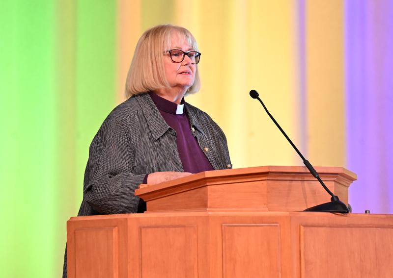 The Rev. Janice Bowker of the Metropolitan Community Church reads “When We Stand Together, We Are Stronger.”