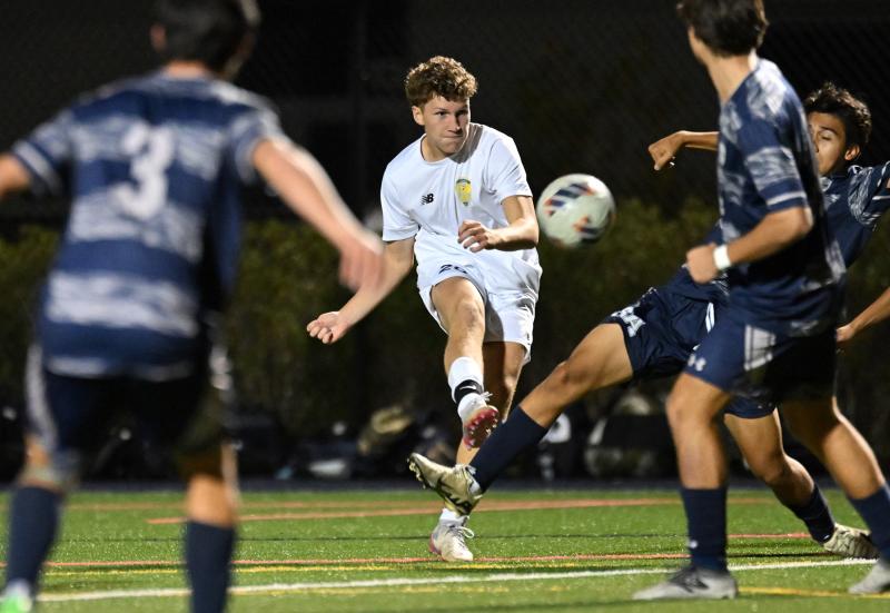 Cape sophomore Austin Tyndall drives the ball through a Sussex Academy crowd of players.