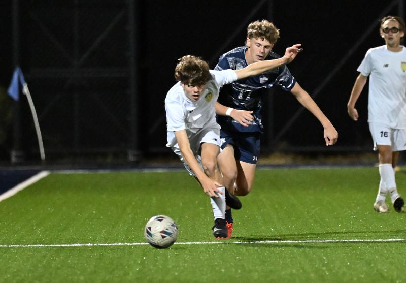 Cape’s John Flynn races to the ball with Sussex Academy’s Chase Ballinger close behind.