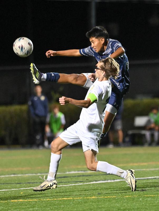 Sussex Academy’s Richard Velasquez-Perez gets major air to kick the ball away from Cape’s Cardin Benjamin.