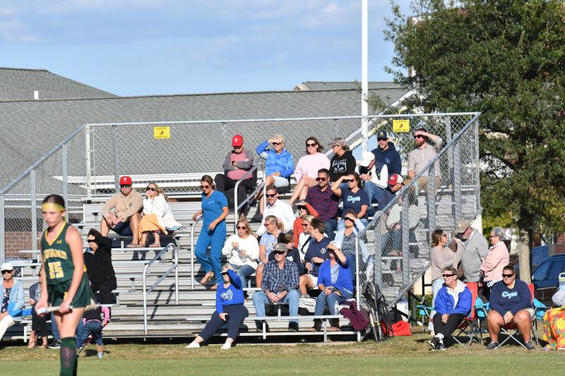 Middle school field hockey fans on a fall afternoon.