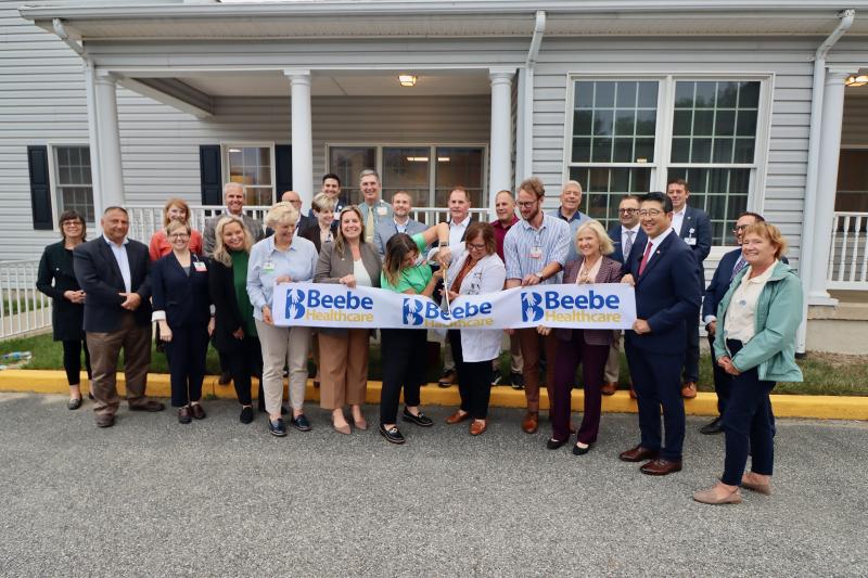 Kerri Wiggins, acute medicine program manager, and Kristie Zangari, DO, medical director of hospitalist service, cut the ribbon on Beebe’s Coordinated Care Center at 1305 Savannah Road. Lt. Gov. Bethany Hall-Long and Dr. David Tam, Beebe president and CEO, are holding the banner on the right. BILL SHULL PHOTO