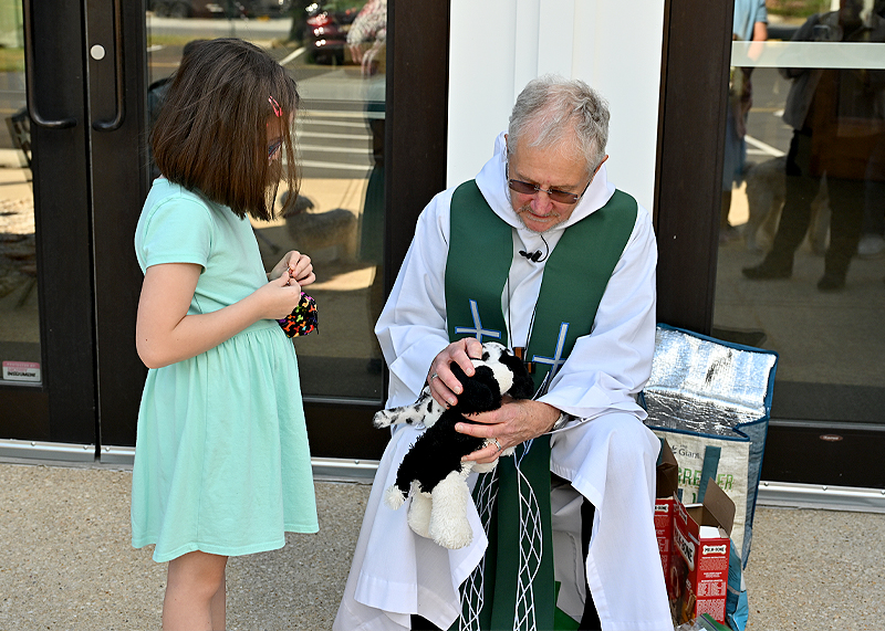 Not all pets were living, but their impact on their owners was just the same. Sara Rae gets Oreo and Marshmallow, her stuffed pets, blessed by Pastor Don Schaefer.