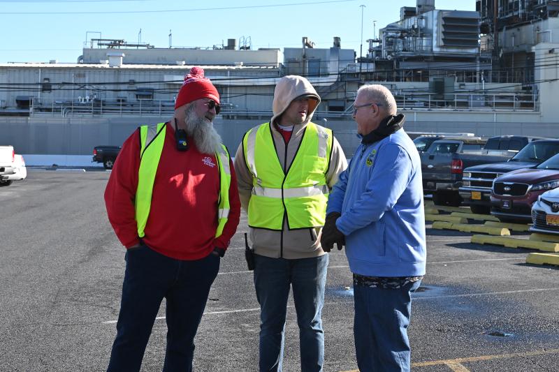 Pausing to confer are (l-r) J.R. LaPearl, director of Mountaire Cares; Zach Evans, senior Mountaire Cares manager; and Richard Duncan, Selbyville mayor.