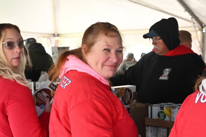 Cynde Pfirrmann takes a short break from volunteering as the line comes to a brief stop.