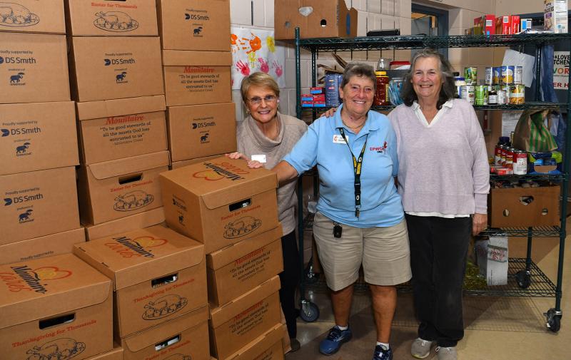 Standing with the donations from Mountaire are (l-r) lay minister Gwen Osborne, coordinator of food donations Dotti Outland and volunteer Maureen Knesel.