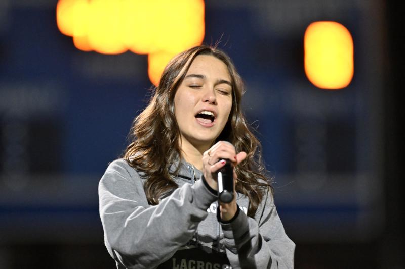 Sussex Academy sophomore Stella Carmen sings the national anthem before the contest.