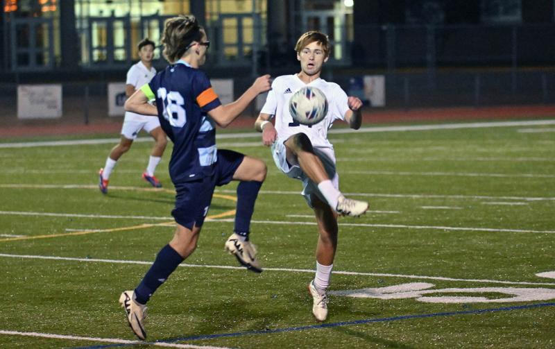 Sussex Academy senior Aleksander Danilenko battles for a loose ball with Cape’s Cardin Benjamin.