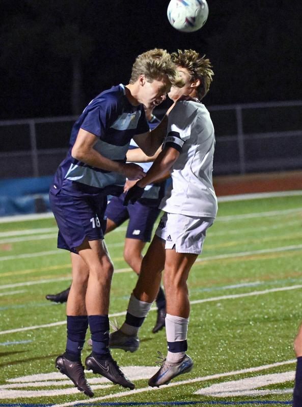 Cape junior Lawson Whaley heads the ball out of the Sussex Academy offensive area and away from Seahawks junior George Sapna.
