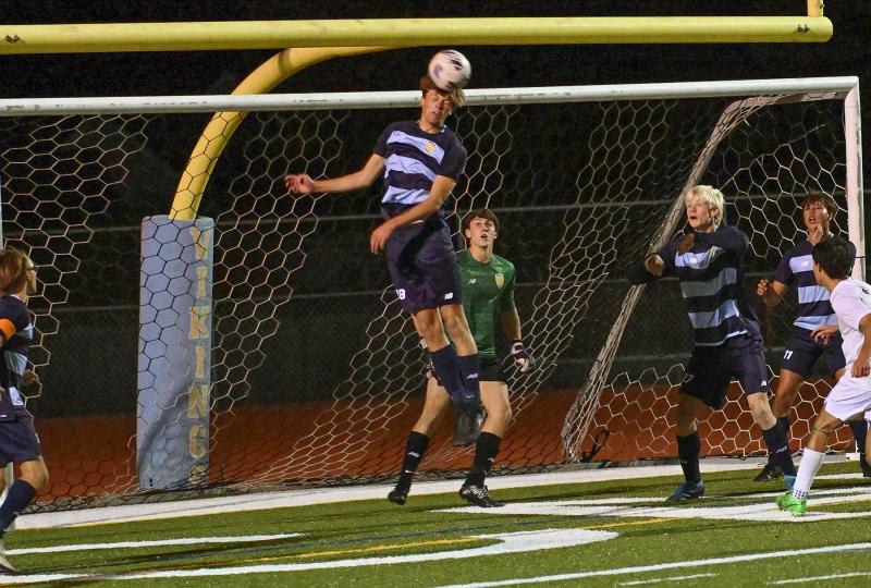 Cape junior defender Lawson Whaley heads the ball away from the cage.