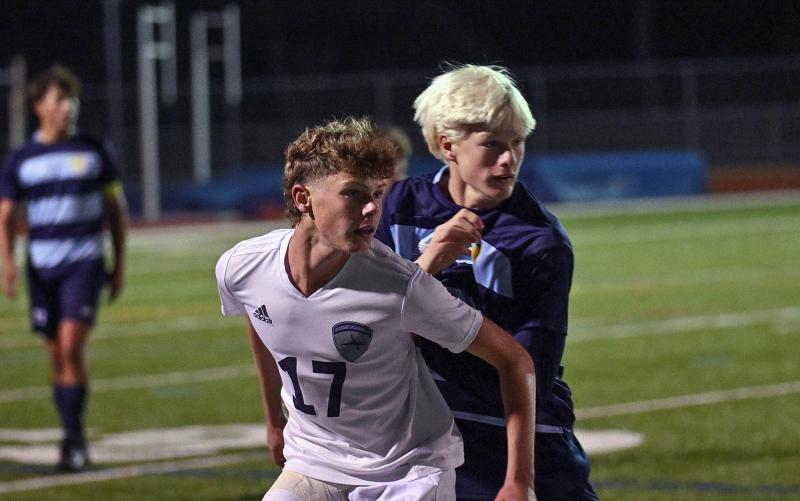 Sussex Academy junior Chase Ballinger, left, and Cape junior Brenner Short battle for position on the sideline.
