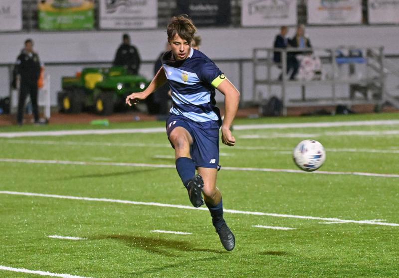 Cape senior defender Jerzy Haines boots a pass across the field.