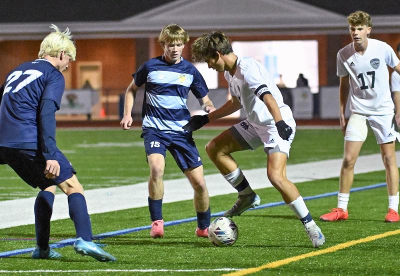 Sussex Academy junior George Sapna works to get out of a double-team from Cape’s Brenner Short and Brad Spiegel.