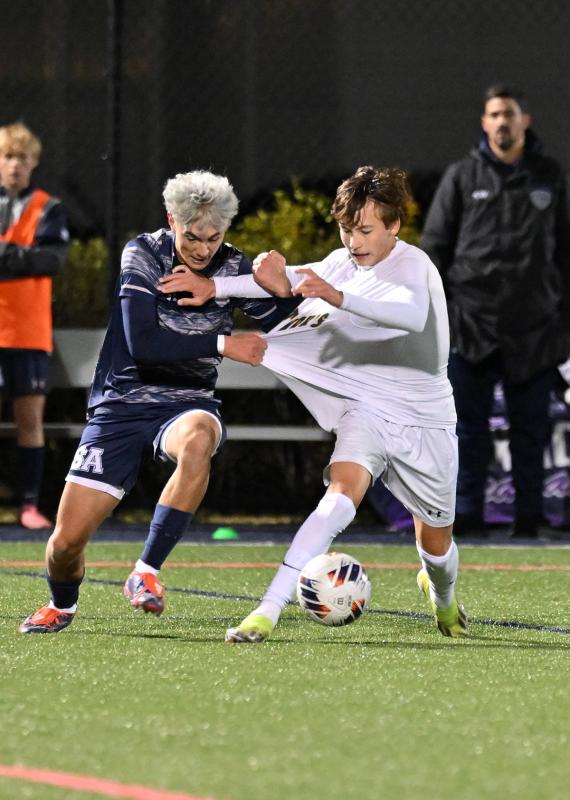 Sussex Academy defender Aiden Villar battles for possession with Saint Mark’s player Gabriel Arick.