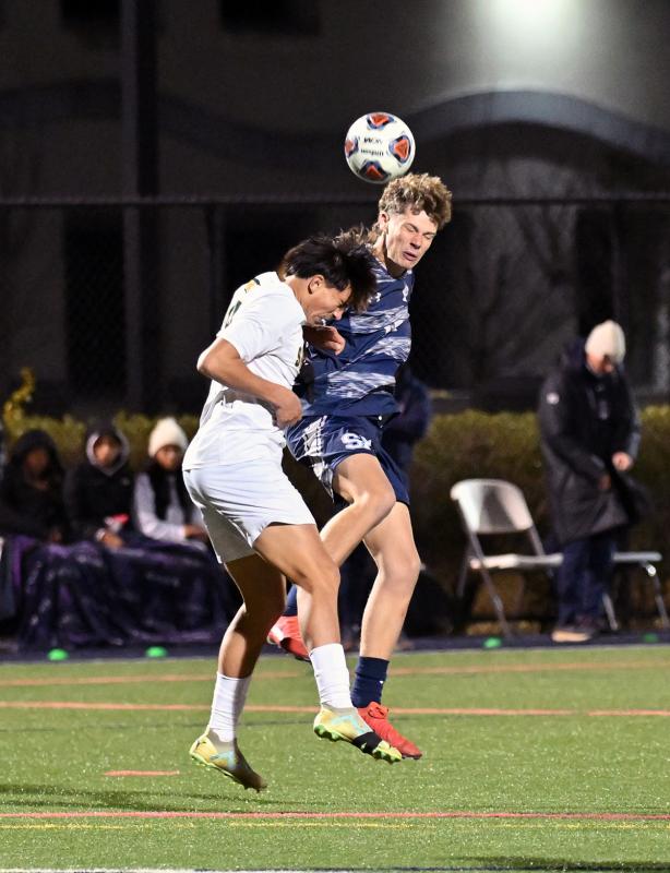 Seahawks forward Chase Ballinger heads the ball toward the Spartans’ goal.