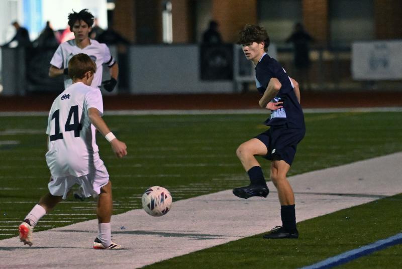 Cape senior Jack Flynn passes the ball up the sideline past Sussex Academy senior Aleksander Danilenko.