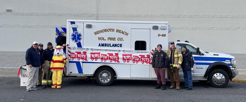 Collecting Toys for Tots during the 2023 Rehoboth Beach Volunteer Fire Company Stuff the Ambulance campaign are (l-r) Gil Bernoski, Alex Wenhold, Javier Oquendo, mascot Sparky, Alejandro Oquendo, Jeff Polashak and Charles Marshall. SUBMITTED PHOTO