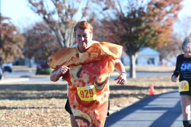 Laurie Milnes runs as a slice of pizza to a time of 43:18 at the Nicola Pizza 5K. DAVE FREDERICK PHOTOS