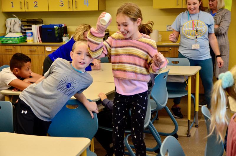 Evelyn Tartal hopped up and down to provide a little more shake while churning butter during Lewes Elementary fourth-graders’ Colonies Day Nov. 15. Thomas Marshall is the photobomber. AARON R. MUSHRUSH PHOTOS