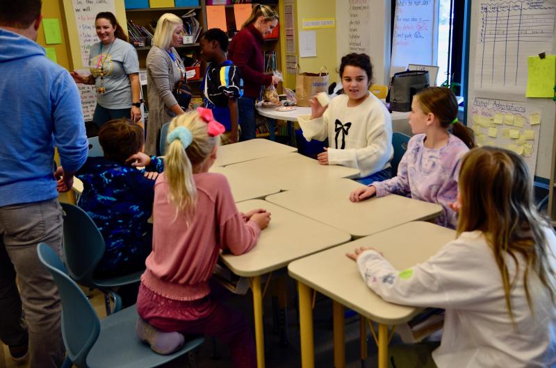 Lucia Zingone shakes the butter while her classmates Harper Michener, Madison Pratt, Maddie Weiland, and Adam Deyak await their churn.