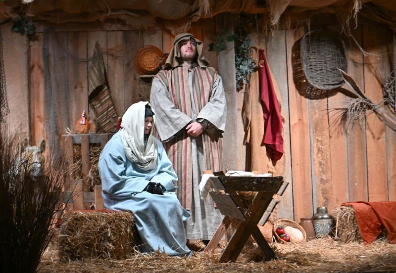 Madi Short, left, and Jonathan Stokley portray Mary and Joseph during the living nativity on The Circle in Georgetown.