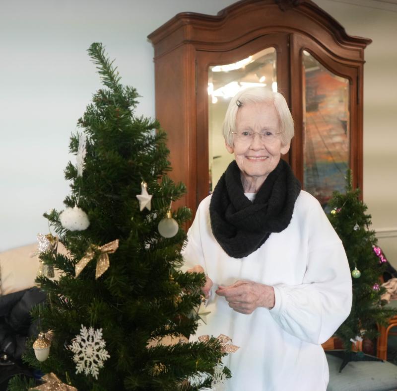 Becky McCarty makes quick work of decorating her tree.