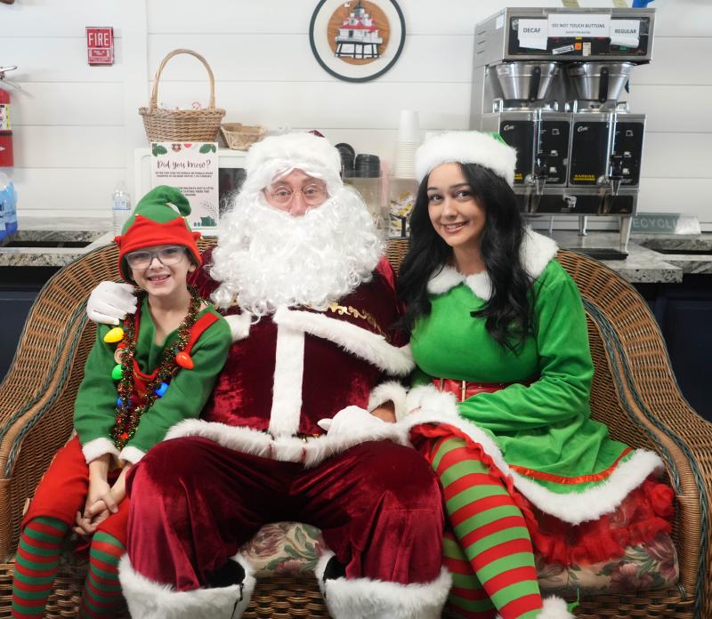 Tripp Silicato, 8, sits with Santa and Mrs. Claus.