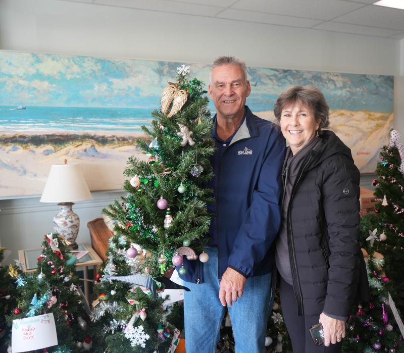 Debbie and Bob Rementer show off the evergreen they decorated at Trees of Cheer.