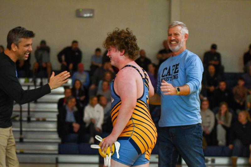 Charlie Gifford is congratulated by Fred Thomas coaches Chris Pleasanton and Chip Wilt.