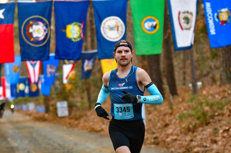 Half-marathon winner Phillip Duncan heads through Flag Alley en route to a time of 1:08:55.